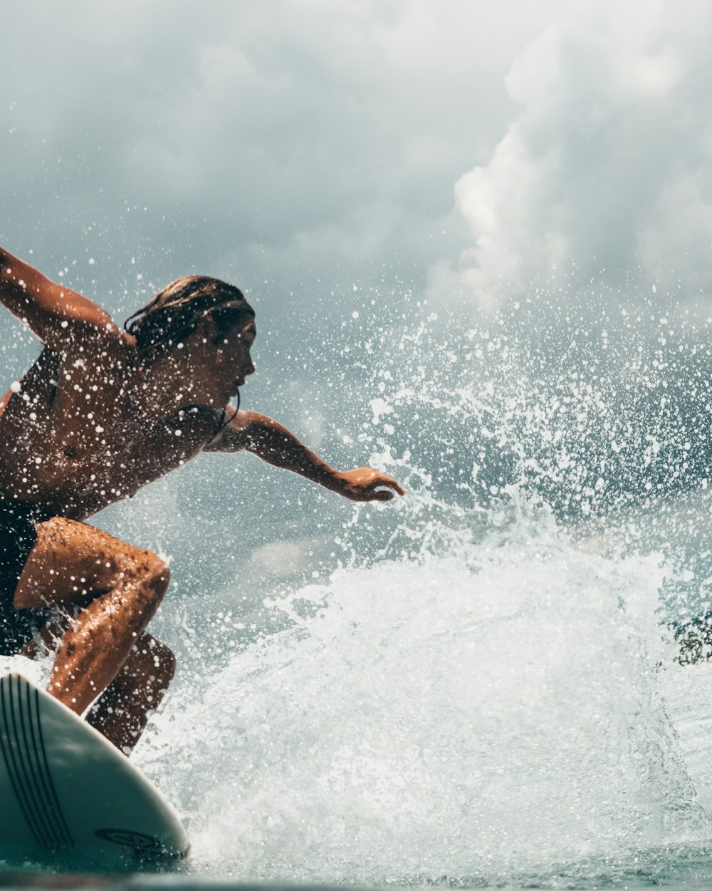 Surfer throwing spray off the top